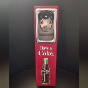 Coca cola bottle opener with cap catch